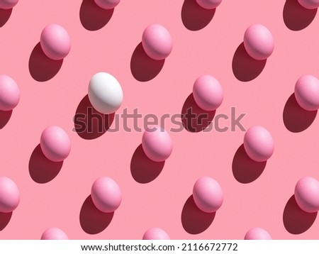 Abstract Easter background. A pattern of pink and white eggs on a pink background.
