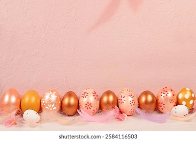Abstract Easter composition with pink and gold decorated eggs, feathers, flowering branches and flowers. Screen banner with space for greeting text, Happy Easter concept.