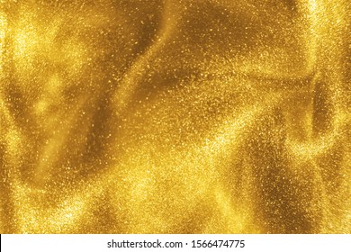 Abstract elegant, detailed gold glitter particles flow with shallow depth of field underwater. Holiday magic shimmering luxury background. Festive sparkles and lights. de-focused.