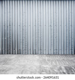 Abstract Empty Garage Interior With Ridged Metal Wall And Concrete Floor