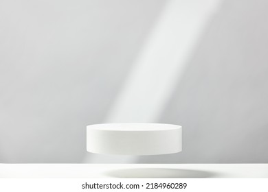 Abstract empty white podium with geometric shadows on blue background. Mock up stand for product presentation. 3D Render. Minimal concept. Advertising template - Shutterstock ID 2184960289
