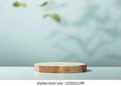 Abstract empty Wood slice podium with eucalyptus leaves and shadows on blue background. Mock up stand for product presentation. 3D Render. Minimal concept. Advertising template - Shutterstock ID 2232911789