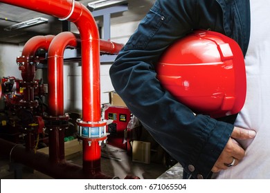 Abstract Engineer Contractor Holding Red Helmet With Fire Protection System Background