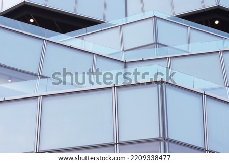 Abstract exterior image of zigzag balconies pattern with aluminum structure and glasses panels show strong geometry form for graphic background use.
