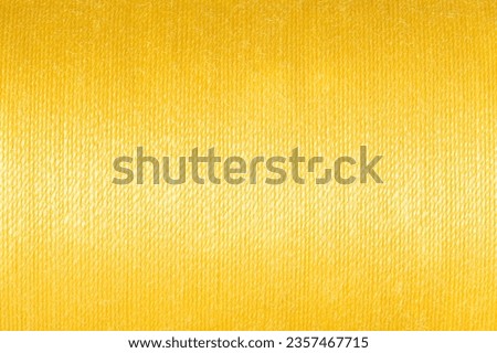 Abstract fabric texture background, close up picture of yellow color thread, macro image of textile surface, wallpaper template for banner, website, backdrop, poster.