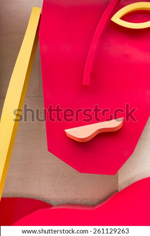Abstract Face of a Woman (Handbag Heads, Bruce McLean). This is a piece of art publicly displayed just off Oxford Street in London. It is made of metal and painted in bright yellow and red colours.