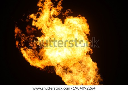 abstract flame texture. Fire column of yellow-red fire of various shapes on a black background