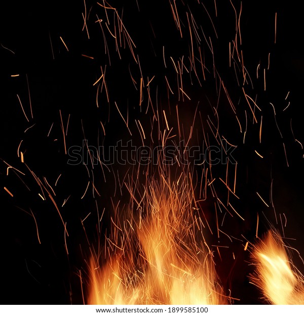 Abstract Flaming Background. Magic Fiery\
Wallpaper. Flames Of Fire And Sparks Isolated On Black Background.\
Flying Sparks Background,  Closeup View. Bonfire Flaming In The\
Night. Energy Concept.