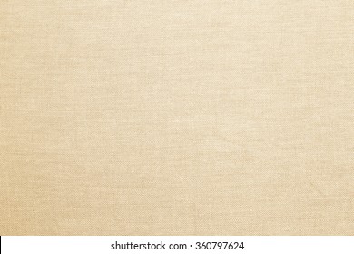 Abstract flat bright cream tan colored fabric textile texture background.