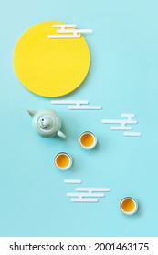 Abstract Flat Lay Conceptual Moon And Tea Set Still Life On Pastel Coloured Background.