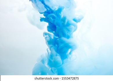 Abstract Flowing Liquid Or Blue Ink In Water On A White Background. It Looks Like Smoke Or Cloud. Or Zero Gravity.