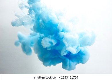 Abstract Flowing Liquid Or Blue Ink In Water On A White Background. It Looks Like Smoke Or Cloud. Or Zero Gravity.