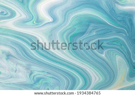 Abstract fluid art background light blue and cyan colors. Liquid marble. Acrylic painting on canvas with turquoise gradient. Watercolor backdrop with white wavy pattern. Stone section.