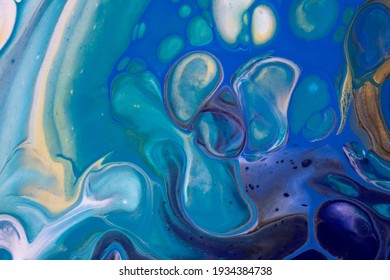 Abstract fluid art background navy blue and golden colors. Liquid acrylic painting on canvas with turquoise gradient and splash. Watercolor backdrop with waves pattern.