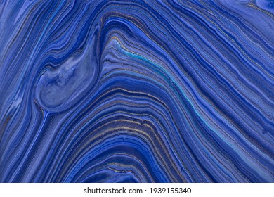 Abstract fluid art background navy blue and golden glitter colors. Liquid marble. Acrylic painting on canvas with dark sapphire gradient. Watercolor backdrop with wavy pattern. Stone section.