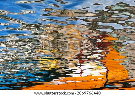 Abstract fluid shapes background.  Reflection detail of colored boats in the water canal, Aveiro, Portugal. yellow bright reflected water. reflection. colorful texture. Aqua, liquid. like a painting