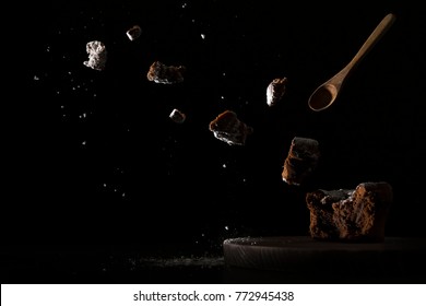 Abstract Food Photography By Exploding Schoko Cup Cake With Spotlight On A Black Background 