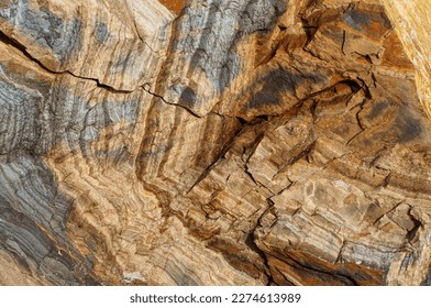 Abstract geologic background featuring a stunning display of natural rock formations with intricate layers and earthy colors creating a unique and captivating visual texture.