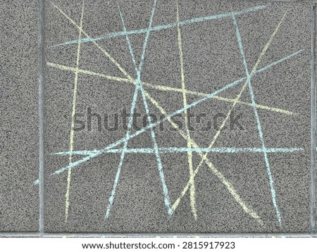 Abstract geometric background featuring intersecting chalk lines drawn on a rough granular grey wall texture. This hand-drawn pattern represents concepts of connection, network, complex paths, structure, or creative thinking.