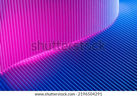 Abstract geometric background with magenta and blue hues. Corrugated lines futuristic backdrop.