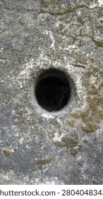 Abstract Geometric Circular Void in Weathered Mossy Concrete Surface