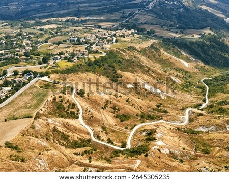 Abstract Geometric Pattern From House Roofs With Orange Red Colored Shingle With Road In San Marino	
