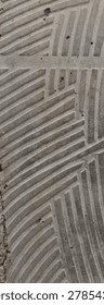 Abstract geometric pattern on a textured surface. Diagonal and perpendicular parallel lines create a modern, industrial aesthetic.
