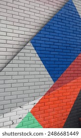 abstract geometric pattern on the wall made of red, blue and white colors solid background