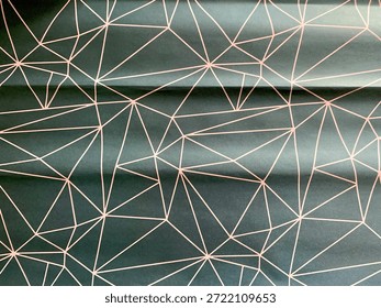 An abstract geometric pattern with thin rose gold lines on an elegant dark green background. The contemporary design with interconnected polygonal lines creates a dynamic yet orderly visual texture that gives a luxurious and modern feel