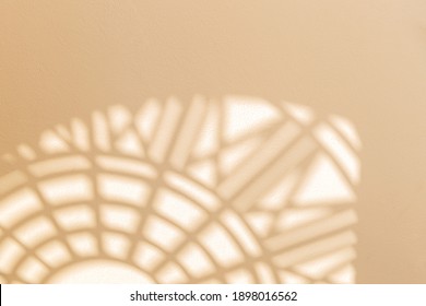 Abstract geometric shadows on yellow natural material wall. Sunny warm background