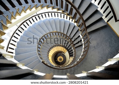 Abstract geometric viewpoint of an elegant winding staircase forming a perfect spiral pattern.
