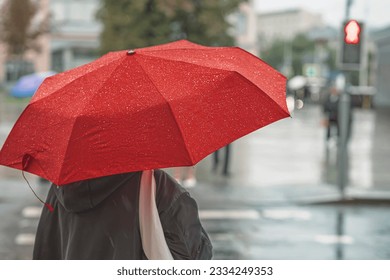 Abstract girl under red umbrella, modern city, rainy evening