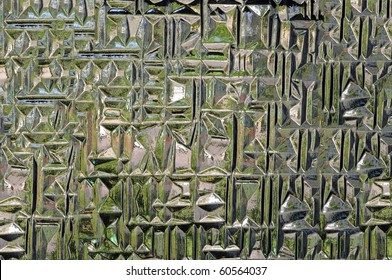 Abstract glass window design with etched rectangular shapes in the glass.