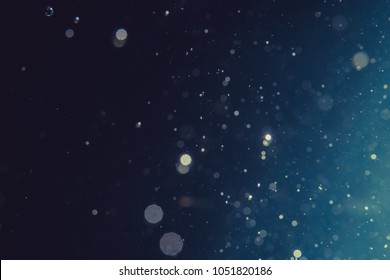 Abstract glitter bokeh on black background