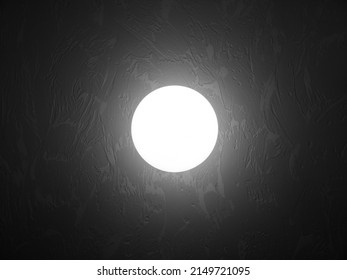 Abstract Glowing Sphere On The Wall In A Dark Room.