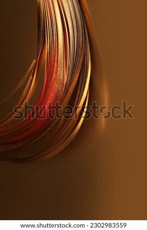 Abstract Gold (bronze) wave lines luxury ribbons on brown copy space background.