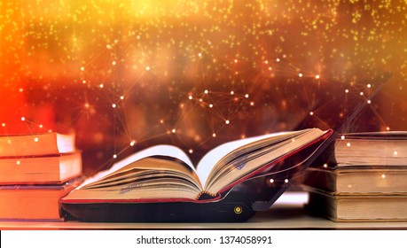 Abstract gold magic book on wooden background