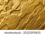 Abstract gold texture background with laser-etched rock wall, golden color, top view, close-up