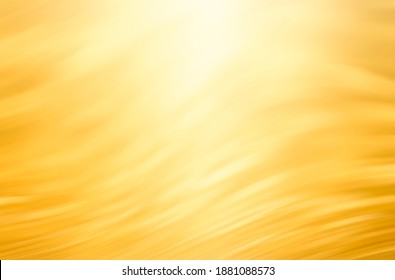 Abstract golden background with bright light on top, which looks like sun light. Blurred gold bg.
