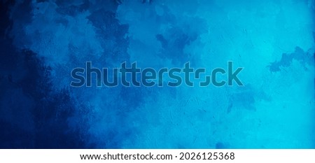 Abstract gradient bright blue background. Panoramic grunge navy blue stucco wall background. Beautiful Wide angle rough stylized texture wallpaper with copy space for design