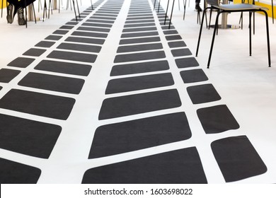 An Abstract Graphic Pattern Simulates The Footprint Of A Car's Tire Tread. Gray Stripes On A White Background On The Office Floor.