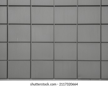 Abstract Gray Cement Tiles Cladding On Building Facade