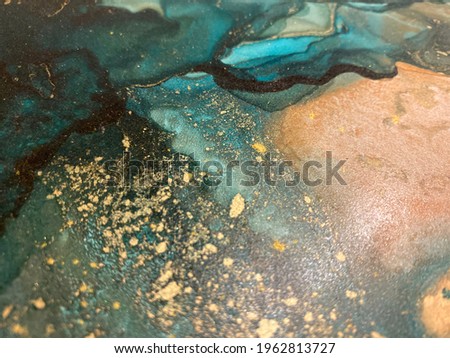 Abstract green art with orange and gold — fluid background with beautiful smudges and stains made with alcohol ink and golden pigment. Emerald texture resembles green stone, watercolor or aquarelle.