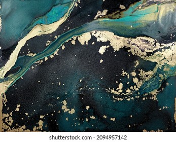 Abstract green background with gold. Green fluid art texture made with alcohol ink and golden paint. Beautiful smudges and stains. Backdrop resembles green marble, landscape, watercolor or aquarelle.