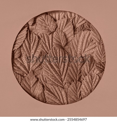 Abstract green background made of raspberry leaves in round-shaped frame. Mockup for your text and sentences. Demonstrating the colors of 2025 - Mocha Mousse.