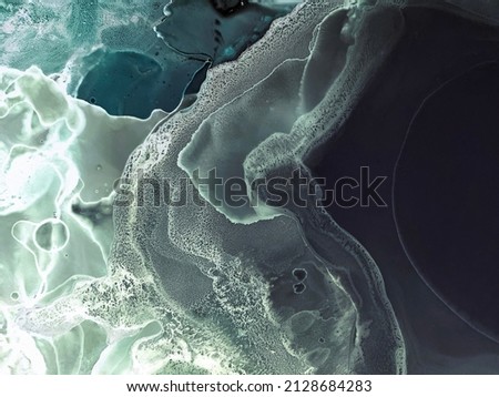 Abstract green with blue and black background. Dark green fluid art texture. Beautiful smudges and stains. Backdrop resembles green marble, emerald, underwater, ocean, water, night sea.