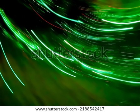 Abstract green light trail vortex. Lights moving in circular green pattern.
