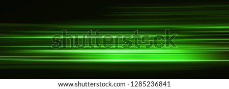 Abstract green light trails in the dark, motion blur effect