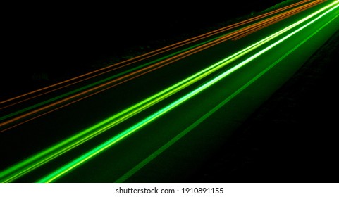 abstract green lights of cars at night - Shutterstock ID 1910891155