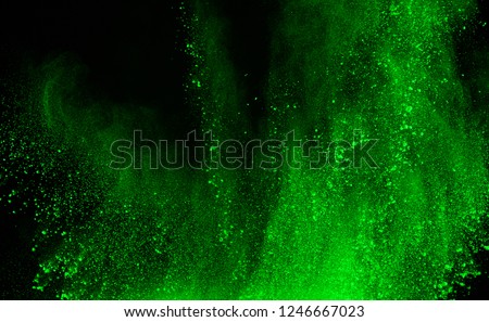 abstract green powder splatted background,Freeze motion of color powder exploding/throwing color powder,color glitter texture on black background